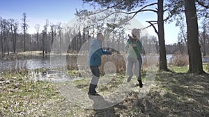 Cinemagraph - seamless loop. man and woman jumping on the shore of the lake. Woman injump - motion photo