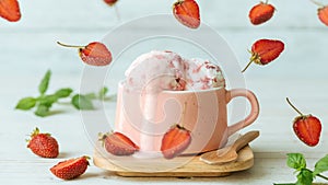 Cinemagraph - Strawberry ice cream in a cup on wooden table.