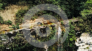 Cinematic aerial drone photo of waterfall and a small pool deep in the rainforest jungle at Amboro National Park, Bolivia photo