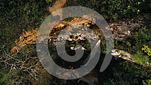 Cinematic aerial drone photo of waterfall and a small pool deep in the rainforest jungle at Amboro National Park, Bolivia photo