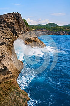 Cinematic aerial landscape shots of the beautiful island of Nusa Penida. Huge cliffs by the shoreline and hidden dream beaches