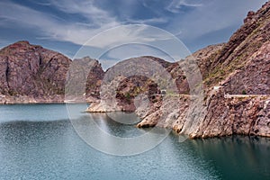 Cinematic lake surrounded by red cliffs in Provincia de Mendoza, Argentina photo