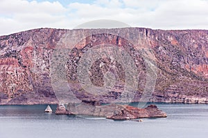 Cinematic lake surrounded by red cliffs in Provincia de Mendoza, Argentina photo