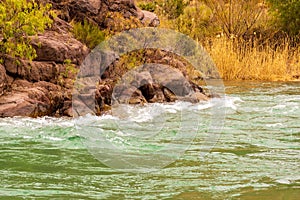 Cinematic river surrounded by red cliffs in Provincia de Mendoza, Argentina photo