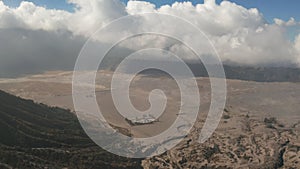 Cinematic shot aerial view of Pura Luhur Poten hindu temple near Mount Bromo volcano in East Java