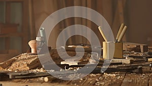 Cinematic shot of table with tools in the garage. Professional carpenter tools, equipment and wooden materials laying on