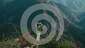 Cinematic woman in traditional sweater in mountain