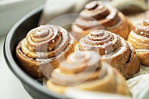 Cinnabon. Homemade glazed buns with sesame and cinnamon. delicious pastries or a warm roll