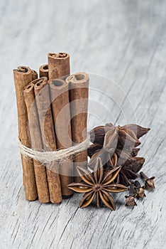 Cinnamon with anise and clove over wood