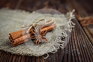 Cinnamon and badian on dark rustic wooden background