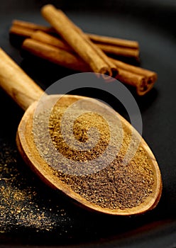 Cinnamon Bark and Powder, cinnamomum zeylanicum against Black Background