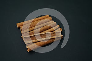 Cinnamon barks isolated on black background , top view