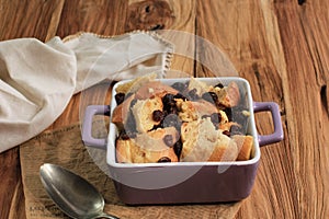 Cinnamon Bread and Butter Pudding with Raisins in Clear Baking Dish, Copy Space for Text