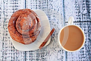 Cinnamon bun with coffee with milk