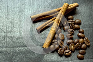 Cinnamon and coffee beans on a black background