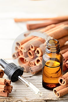 Cinnamon essential oil in the glass bottle