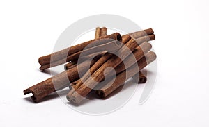 Cinnamon in the form of tubes on white background