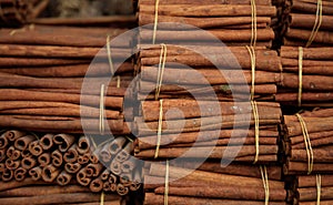 Cinnamon sticks on tied rolls. Canella natural brown aromatic spice background. photo