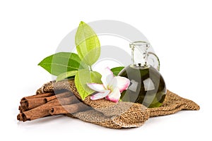 Cinnamon and oil isolated on white surface