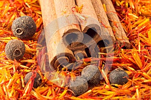 Cinnamon, peppercorn and saffron close-up photo