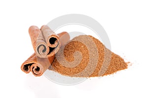 Cinnamon powder and sticks isolated