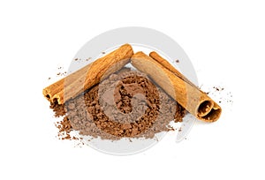 Cinnamon powder and sticks isolated on a white background