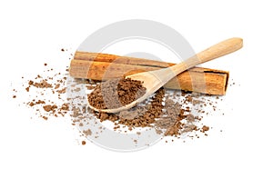 Cinnamon powder and sticks with wooden spoon isolated on a white background