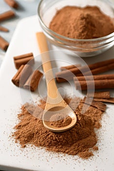 Cinnamon powder on white cutting board