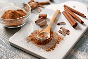 Cinnamon powder on white cutting board