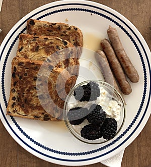 cinnamon raison French toast, sausage links, cottage cheese and blackberries