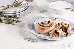 Cinnamon rolls or cinnabon  with icing for Christmas. Homemade traditional winter festive dessert buns. Pastry food for breakfast