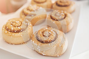 Cinnamon rolls on white plate.
