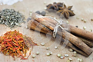 Cinnamon, safron, star anise and peper on a wooden table