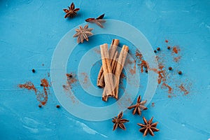 Cinnamon with star anise on a blue background view from above