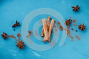 Cinnamon with star anise on a blue backgroundCinnamon with star anise on blue background relief top view