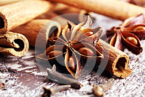 Cinnamon, staranise and cloves. winter spices on wooden background photo