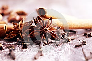 Cinnamon, staranise and cloves. winter spices on wooden background photo