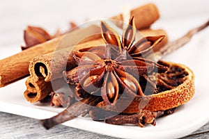Cinnamon, staranise and cloves. winter spices on wooden table photo