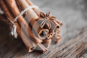 Cinnamon sticks and anise star on a wooden background. Copy, empty space for text