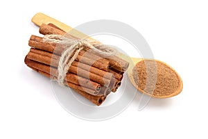 Cinnamon sticks bunch with powder on white background. Top view