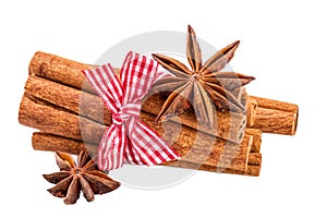 Cinnamon sticks bundle and anise over white.Traditional Christmas spices isolated on white