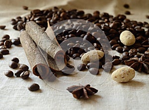 Cinnamon sticks,coffee beans,anise and almond candies still life