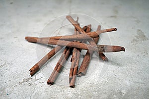 Cinnamon sticks on concrete floor background