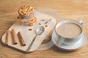 cinnamon sticks, cookies and a cup of coffee/ cinnamon sticks, cookies and a cup of coffee on a wooden background