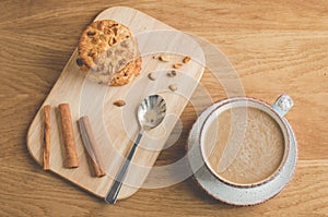 Cinnamon sticks, cookies with nuts and a cup of coffee/cinnamon