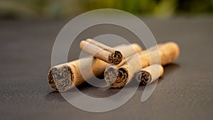 Cinnamon sticks, isolated on dark brown background. photo