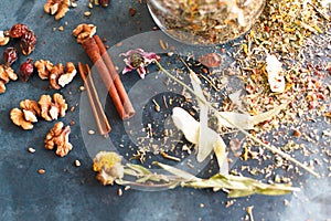 Cinnamon sticks, nuts and a herb collection scattered on a blue