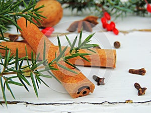 Cinnamon sticks, nuts, spices, berries on vintage wooden background.hite wooden background.