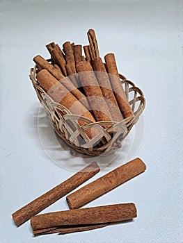 Cinnamon sticks on small wooden basket