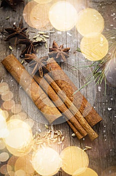 Cinnamon sticks with star anice and cardamom closeup on wood desk. Christmas spices